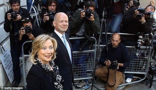 U.S. Secretary of State Hillary Clinton walks with British Foreign Secretary William Hague to join Obama at 10 Downing Street
